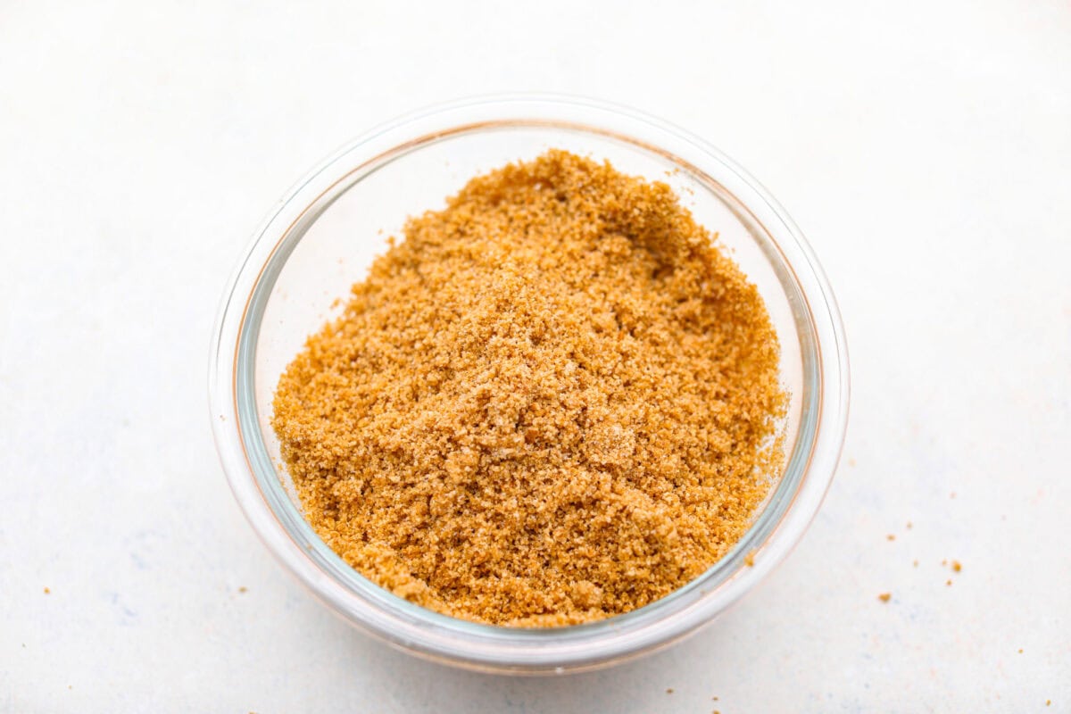 Graham cracker crumbs in a small bowl.