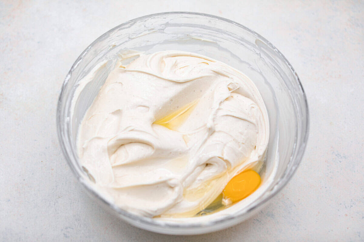 Beat cream cheese and eggs in a bowl.