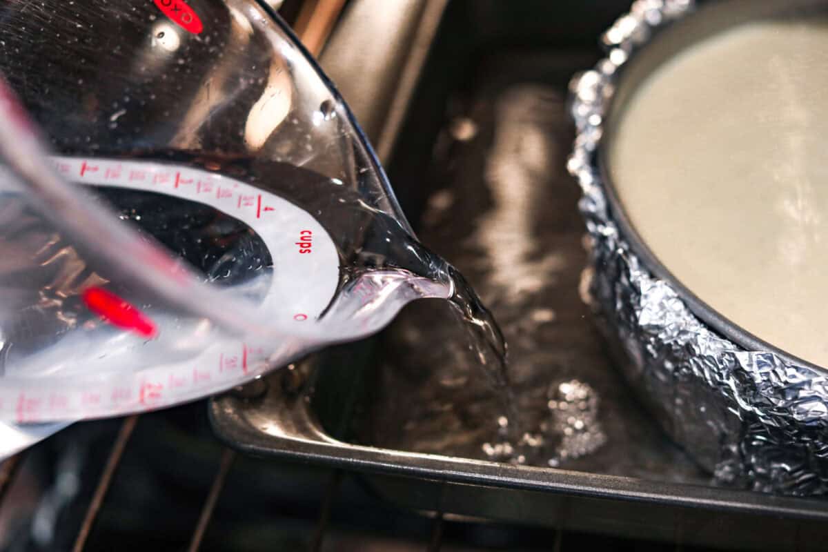 Pouring water into a roasting pan.