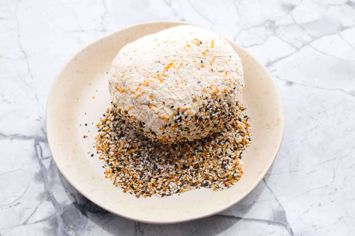 Overhead shot of the ball being rolled in everything bagel seasoning.