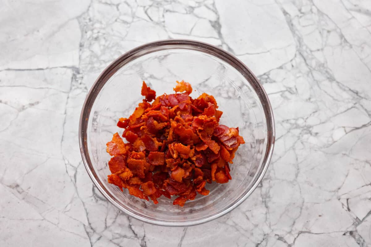 Overhead shot of cooked bacon pieces in a bowl. 