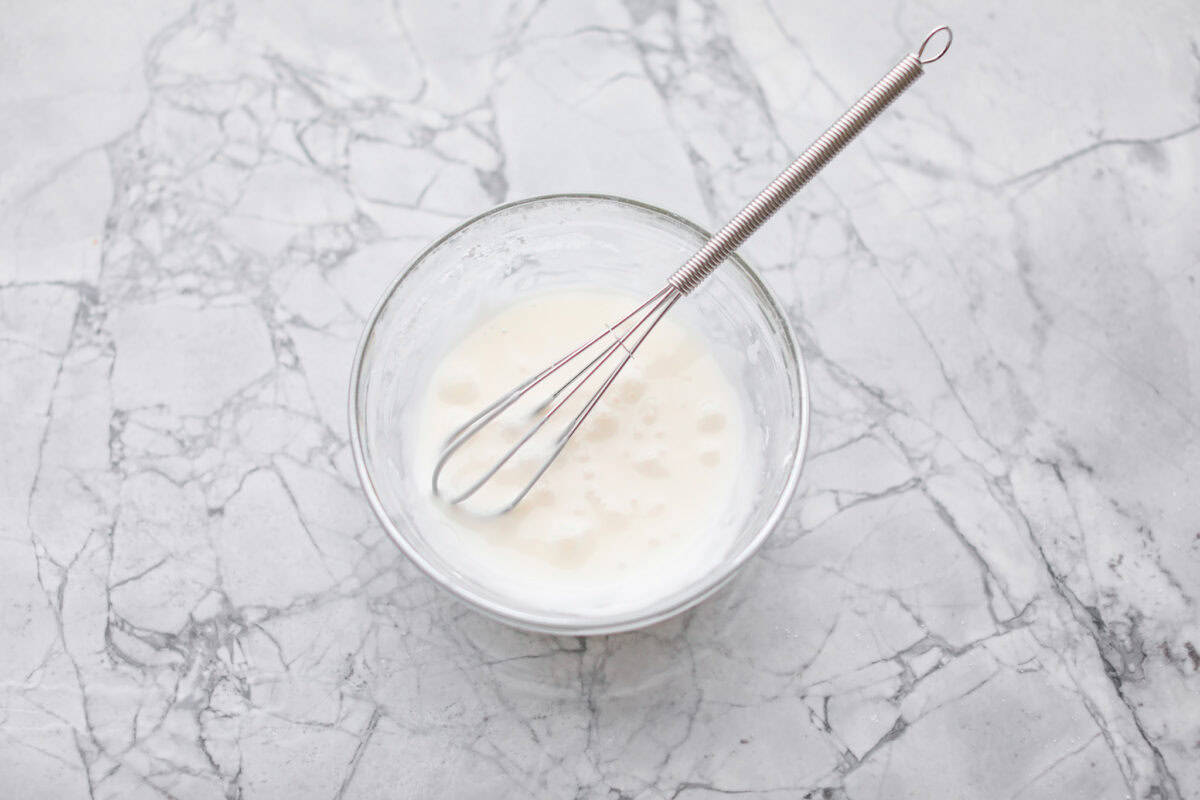 Overhead shot if glaze ingredients whisked together in a bowl. 