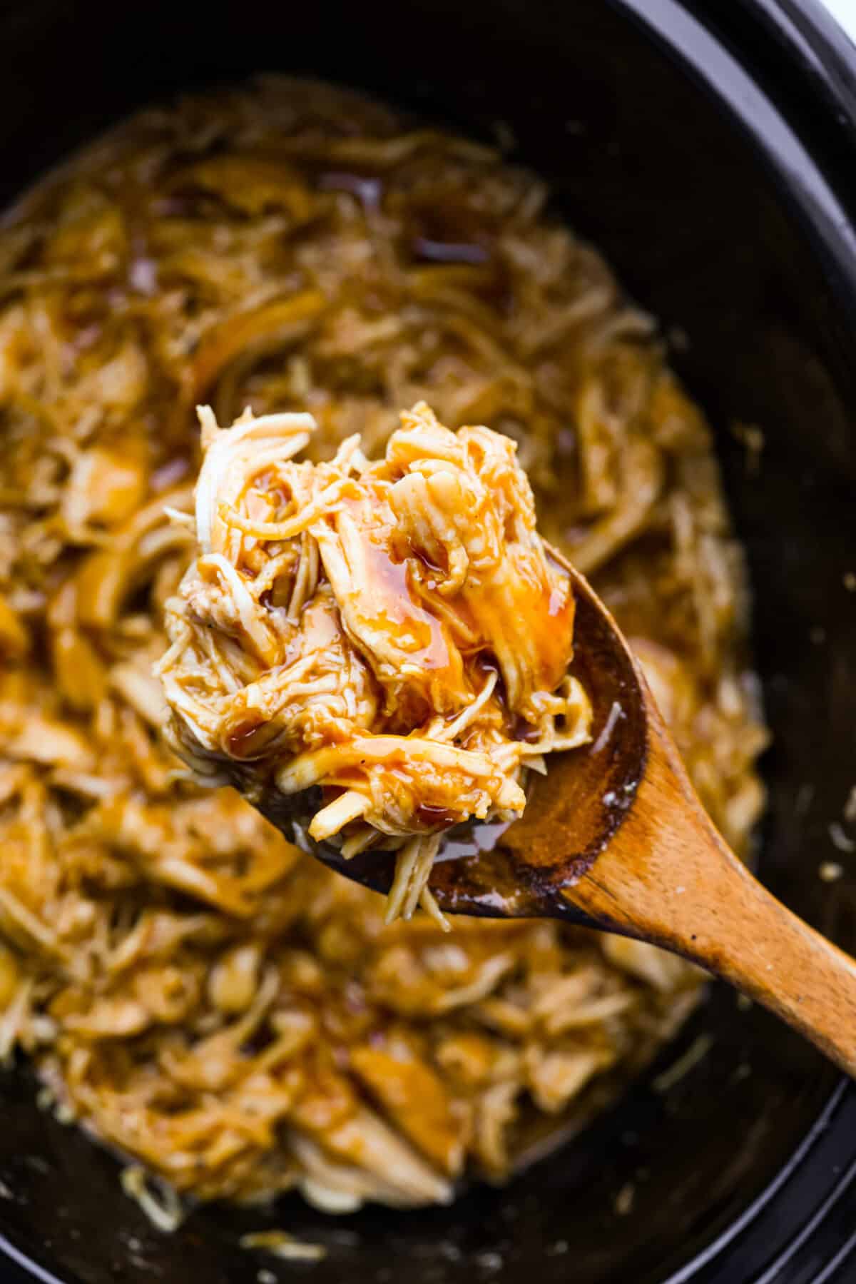 Close up shot of slow cooker shredded BBQ chicken. 