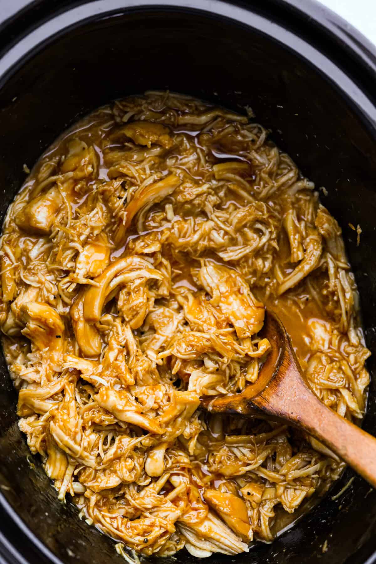 Overhead shot of slow cooker shredded BBQ chicken in the crockpot. 