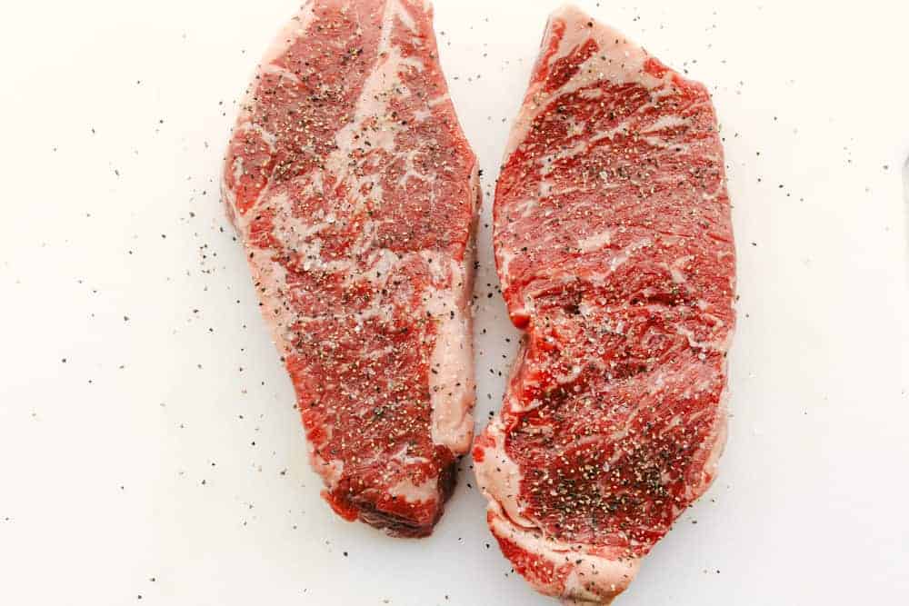 Overhead shot of seasoned steak. 